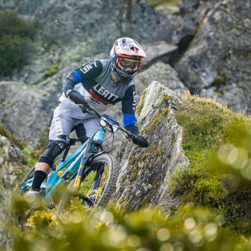 Orange team rider in rocks