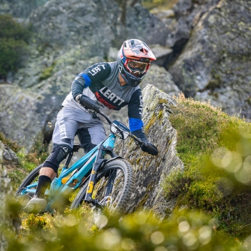 Orange team rider in rocks