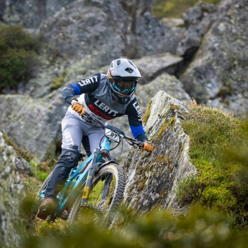 Orange team rider in rocks