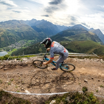 Scenic image of Orange rider with mountains in background