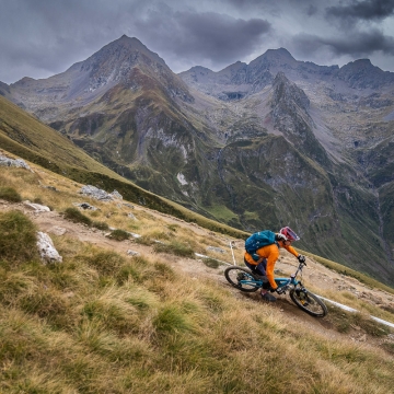 Scenic photo of Orange rider with mountains in background