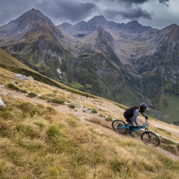 Scenic photo of Orange rider with mountains in background