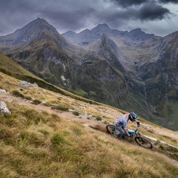 Scenic photo of Orange rider with mountains in background
